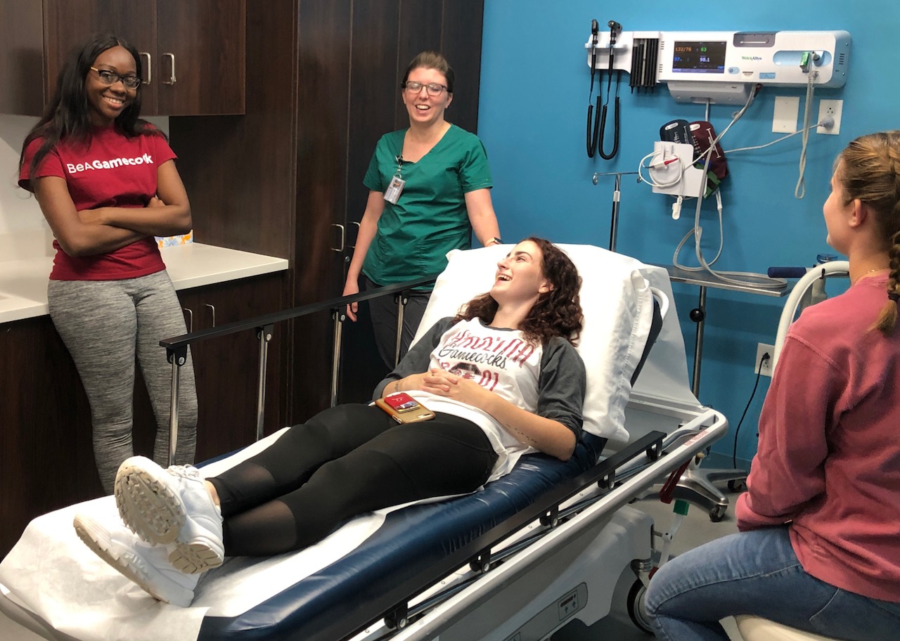 UofSC students and a nurse in an examination room at the Center for Health and Well-Being.